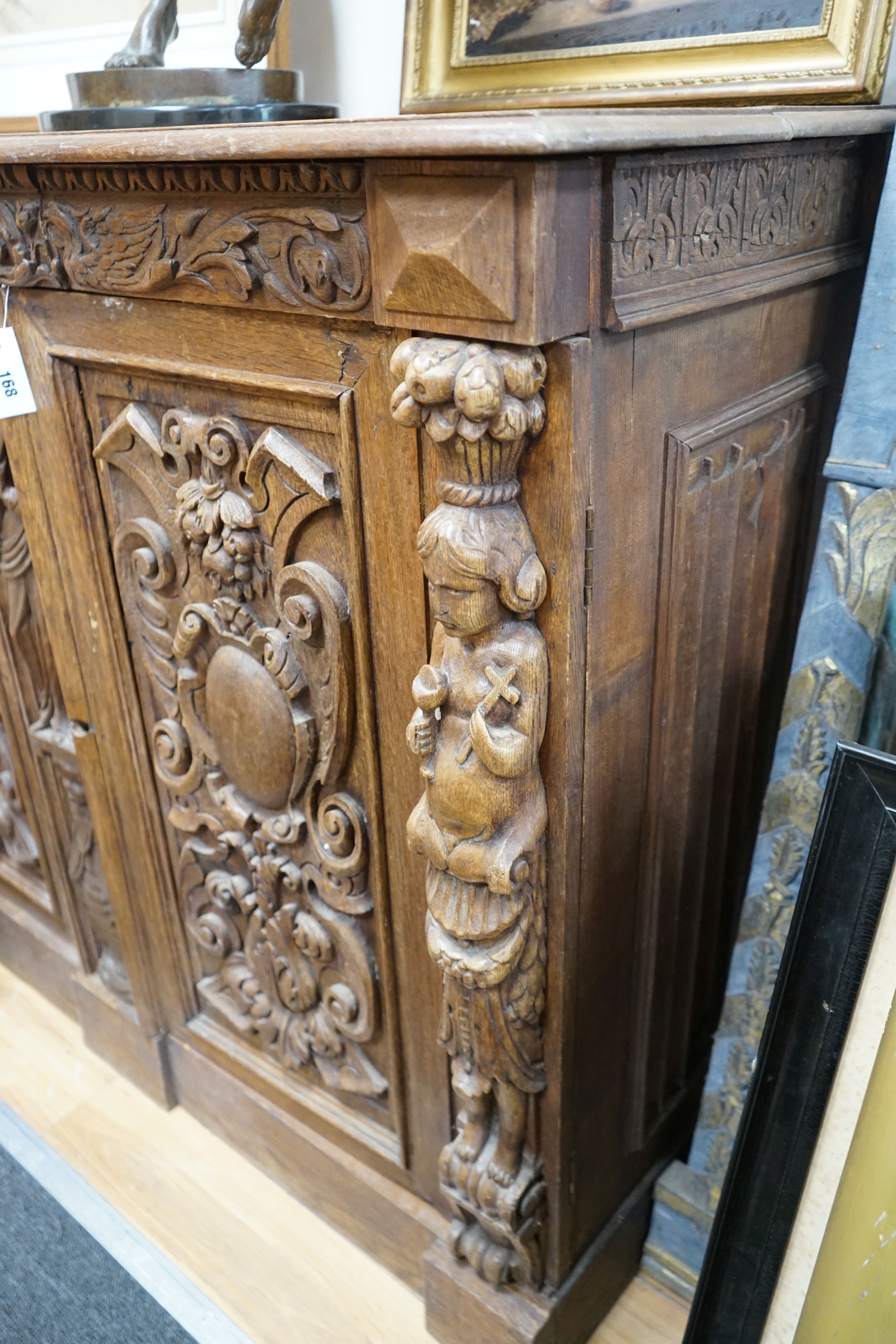 A late 19th / early 20th century Flemish carved oak cabinet section with drawer and pigeon hole interior, width 130cm, depth 52cm, height 107cm